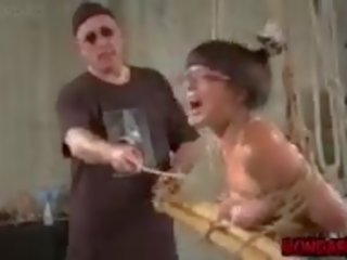 Grown-up Asian Slave Tortured with Metal Dildo and Tit.